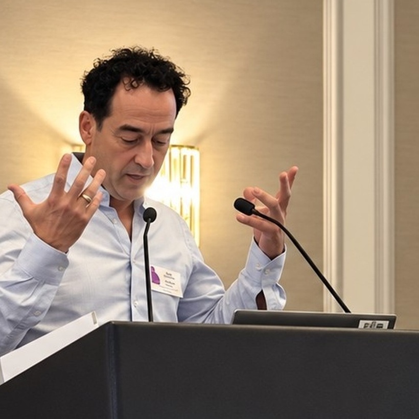 Speaker presenting beside a placental insufficiency slide